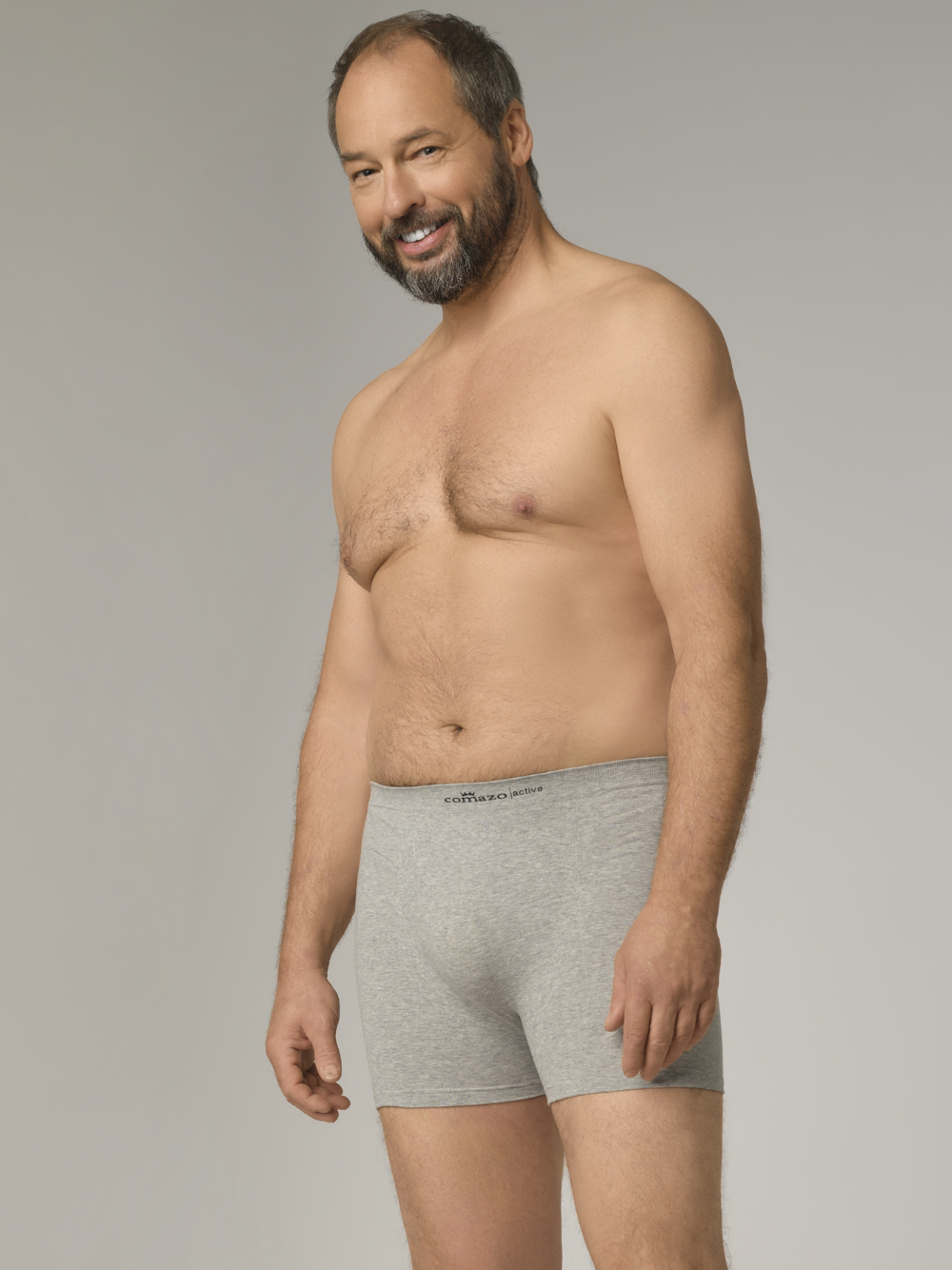Comazo men's seamless trunk in grey melange color. Front view 2: man wearing seamless trunks by Comazo in grey melange color.