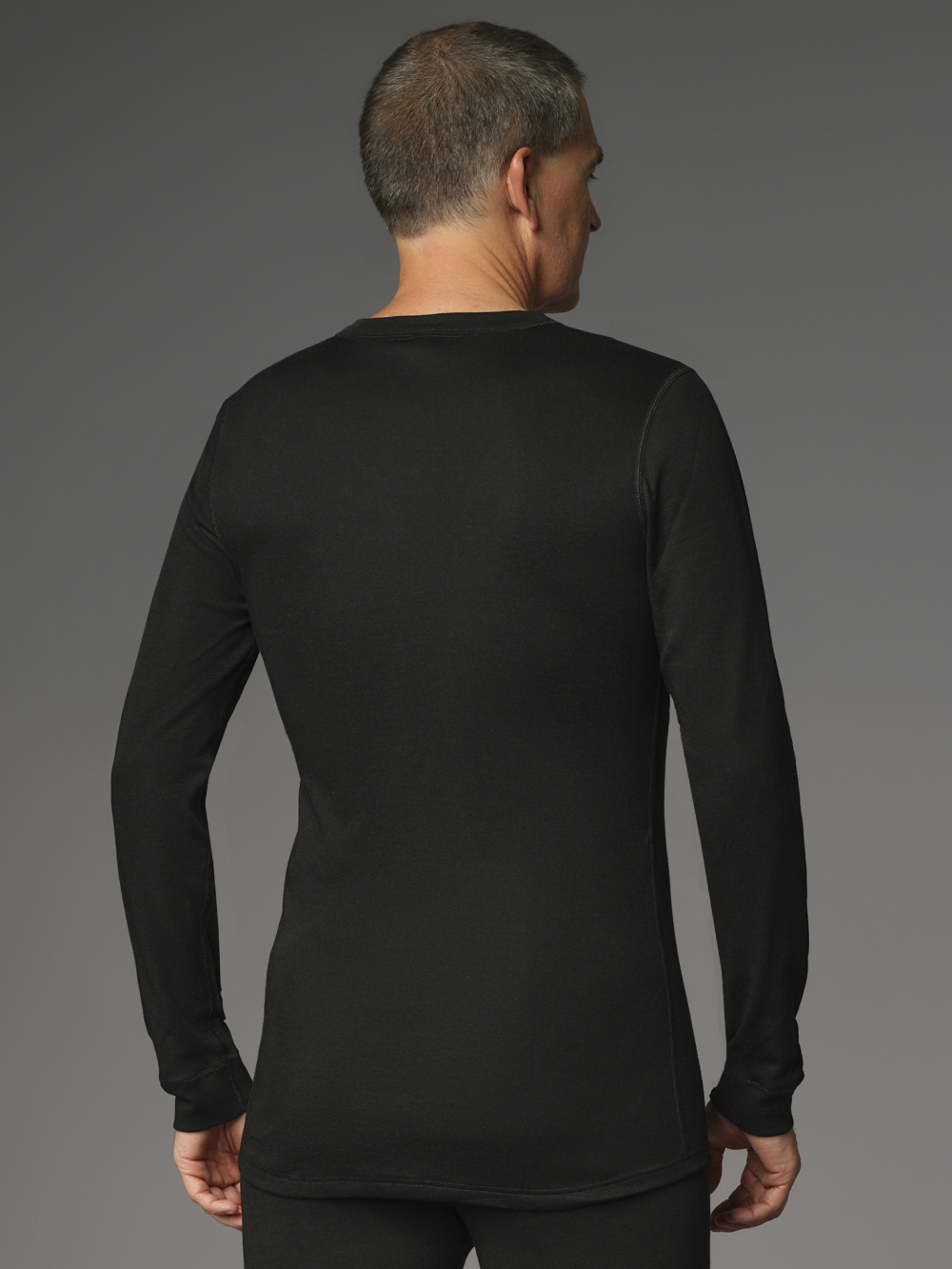 Flame-retardant long-sleeve shirt by Comazo Protect in black color. Rear view: Man wearing flame-retardant long-sleeve shirt by Comazo Protect in black color.
