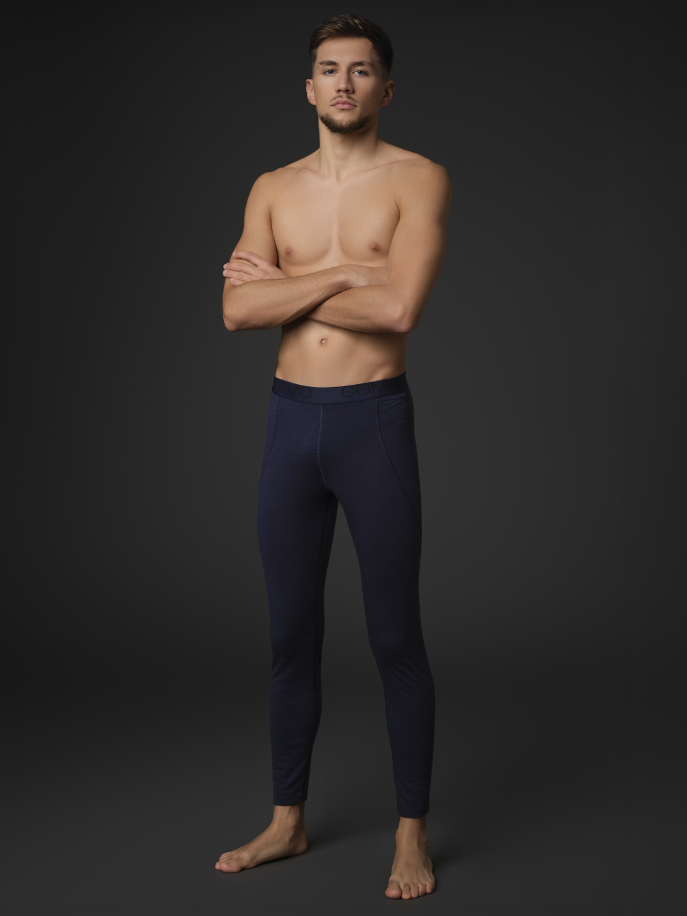 Comazo men's long underpants made of merino wool, color navy. Front view: Man wearing long underpants made of 100% mulesing-free merino wool by Comazo in navy color with Comazo logo waistband.
