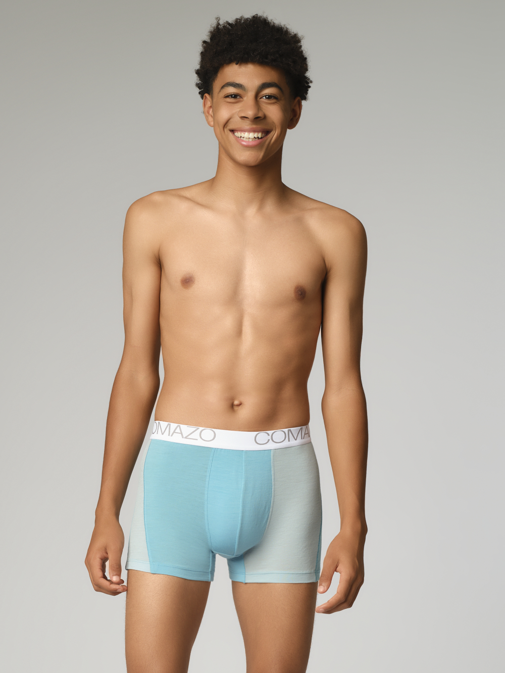 Comazo men's trunks made of merino wool in the color Seablue/Ice. Front view: Man wearing merino wool trunks from Comazo in the color Seablue/Ice with lettering on the waistband.