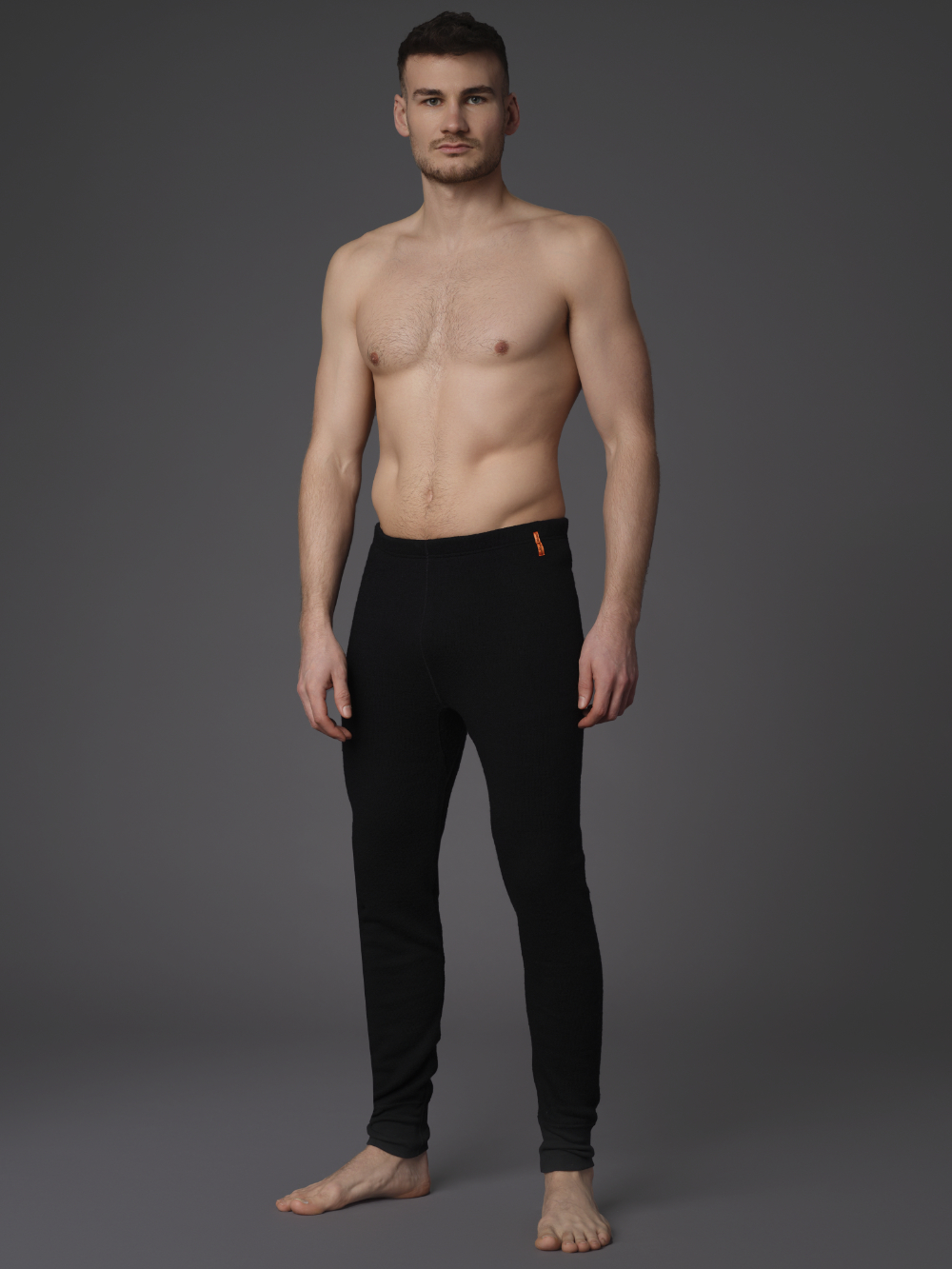 High-quality merino wool functional pants (mulesing-free) by Comazo Protect in black color. Front view: Man wearing High-quality merino wool functional pants (mulesing-free) by Comazo Protect in black color.