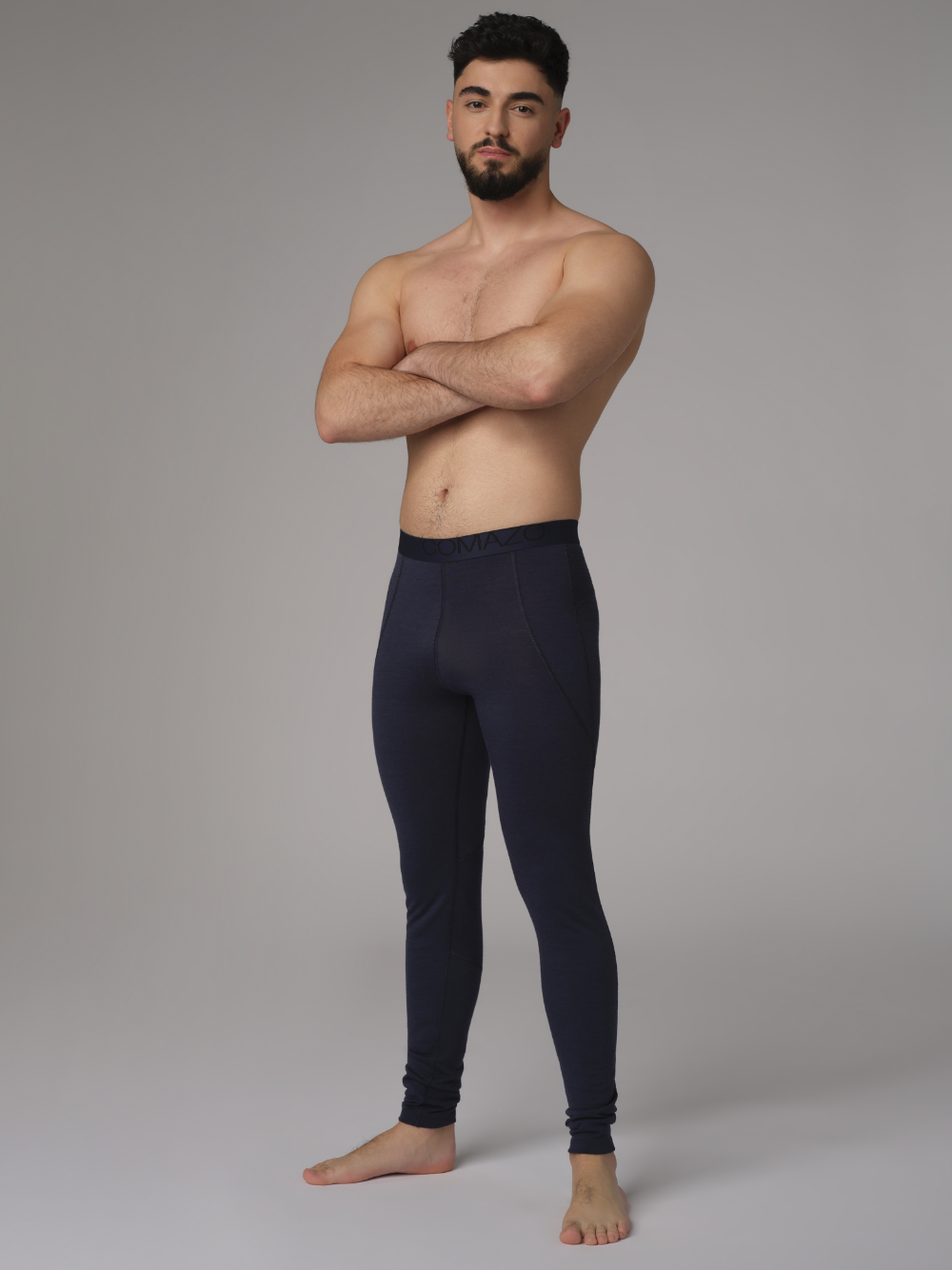 Comazo men's long underpants made of merino wool, color navy. Front view 2: Man wearing long underpants made of 100% mulesing-free merino wool by Comazo in navy color with Comazo logo waistband.