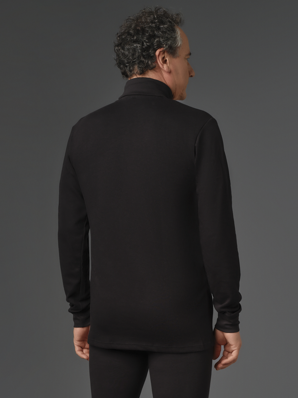 Shirt with turtleneck made of two-layer material by Comazo Protect, color black. Back view: Man wearing a turtleneck shirt made of two-layer material by Comazo Protect, color black.