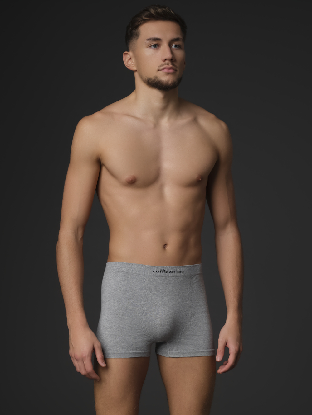 Comazo men's seamless trunk in grey melange color. Front view: man wearing seamless trunks by Comazo in grey melange color.