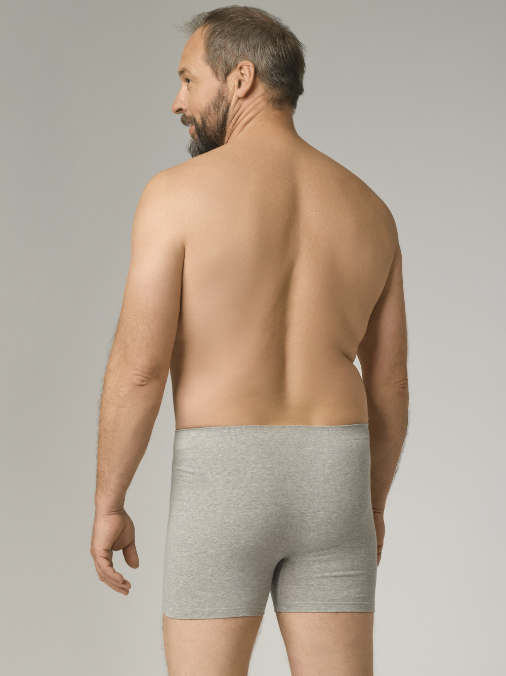 Comazo men's seamless trunk in grey melange color. Rear view 2: man wearing seamless trunks by Comazo in grey melange color.