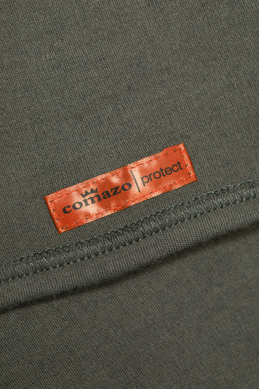 Flame-retardant tubular scarf by Comazo Protect in sage green color. Detail image of flame-retardant tubular scarf by Comazo Protect in sage green color.