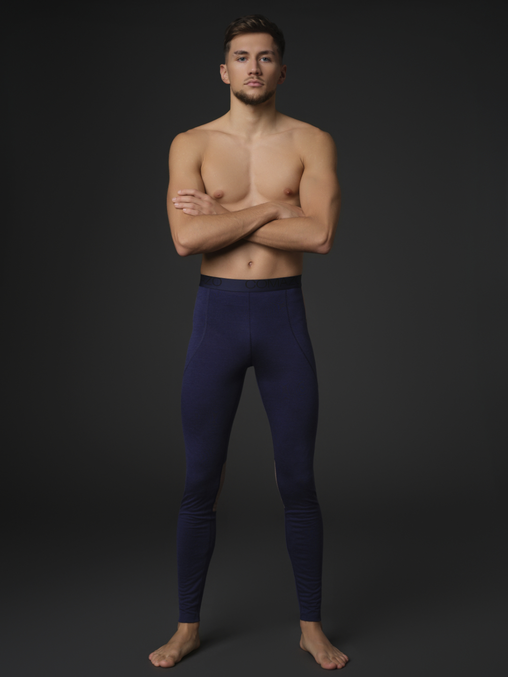 Comazo men's long underpants made of merino wool, color dark blue/coffee. Front view: Man wearing Comazo men's long underpants made of merino wool, color dark blue/coffee.