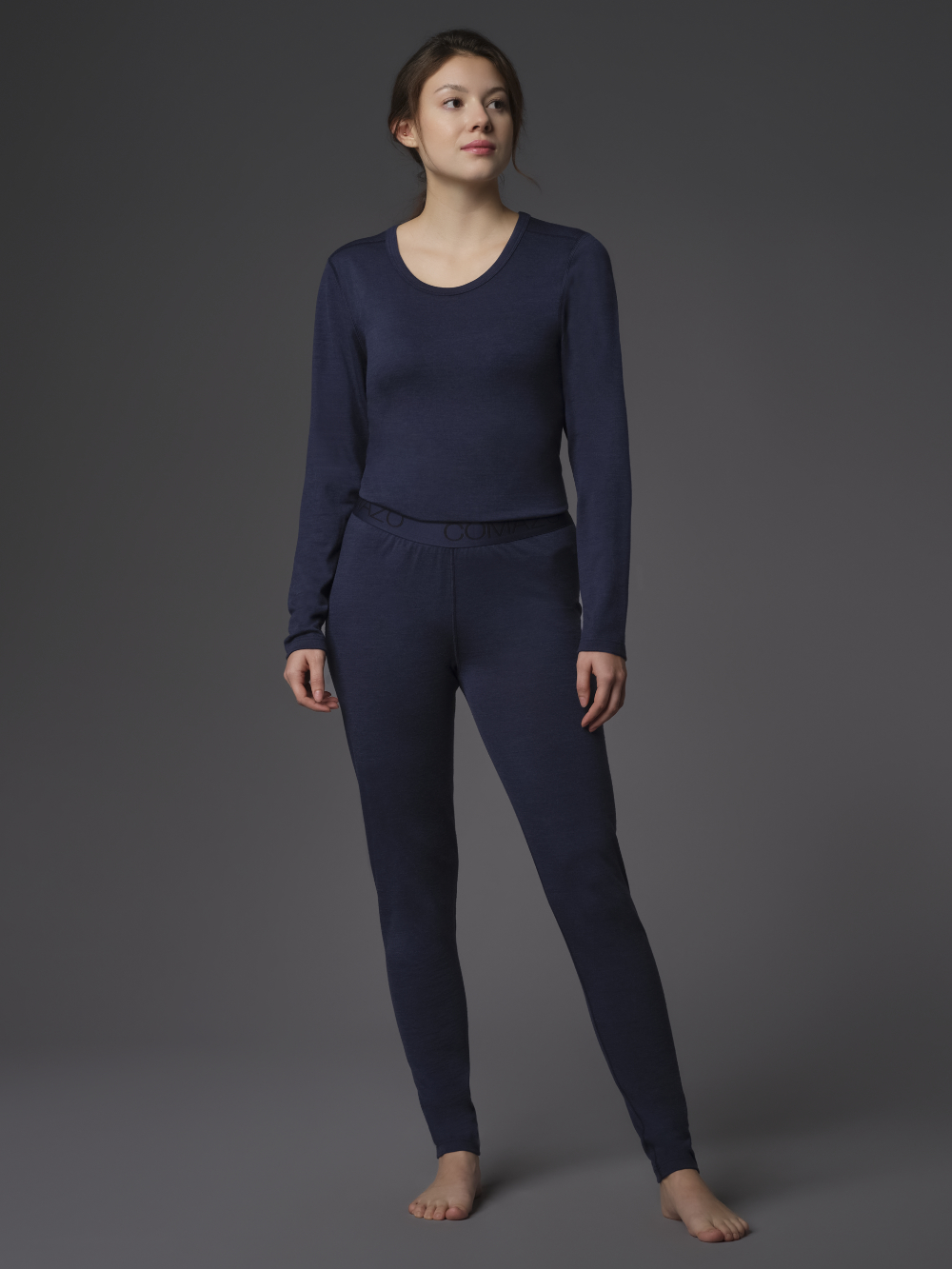 Functional pants made of 100% merino wool for women by Comazo Protect, color navy. Front view: Woman wearing functional pants made of 100% merino wool for men by Comazo Protect, color navy.