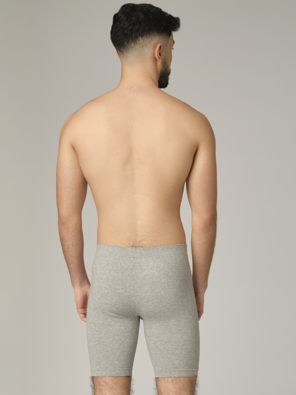 Comazo men's seamless pants with longer legs, color grey melange. Rear view: man wearing seamless pants with longer legs by Comazo in grey melange color.