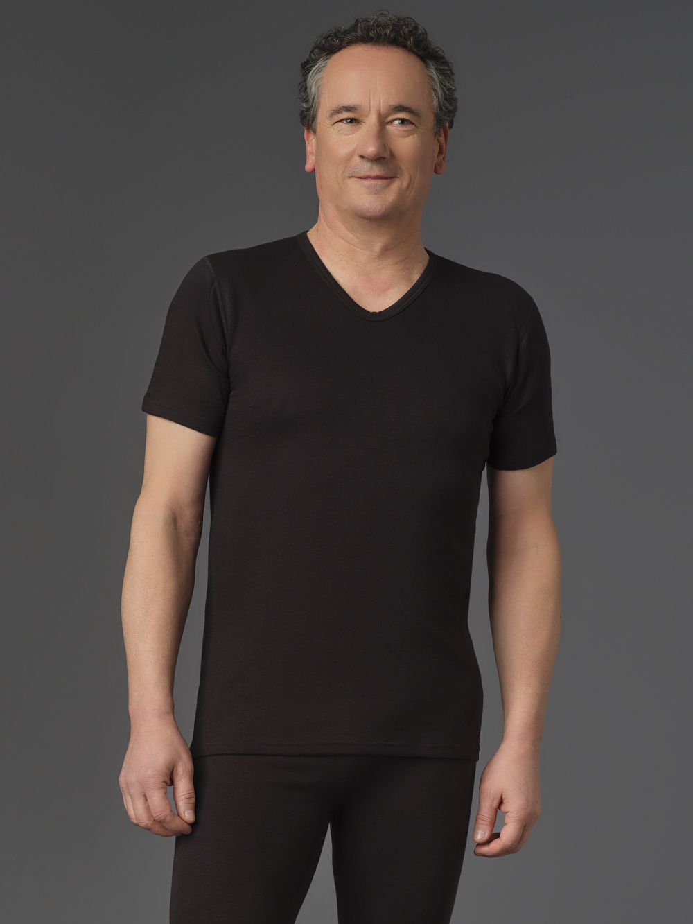Short-sleeve V-neck shirt made from two-layer material by Comazo Protect in black color. Front view: Man wearing Short-sleeve V-neck shirt made from two-layer material by Comazo Protect in black color.