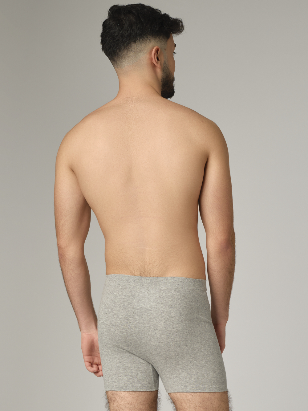 Comazo men's seamless trunk in grey melange color. Rear view: man wearing seamless trunks by Comazo in grey melange color.