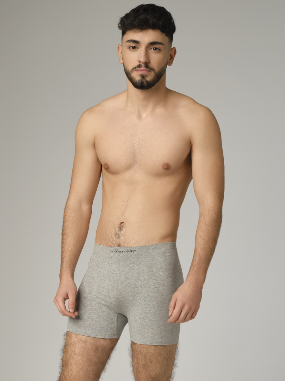 Comazo men's seamless trunk in grey melange color. Front view: man wearing seamless trunks by Comazo in grey melange color.