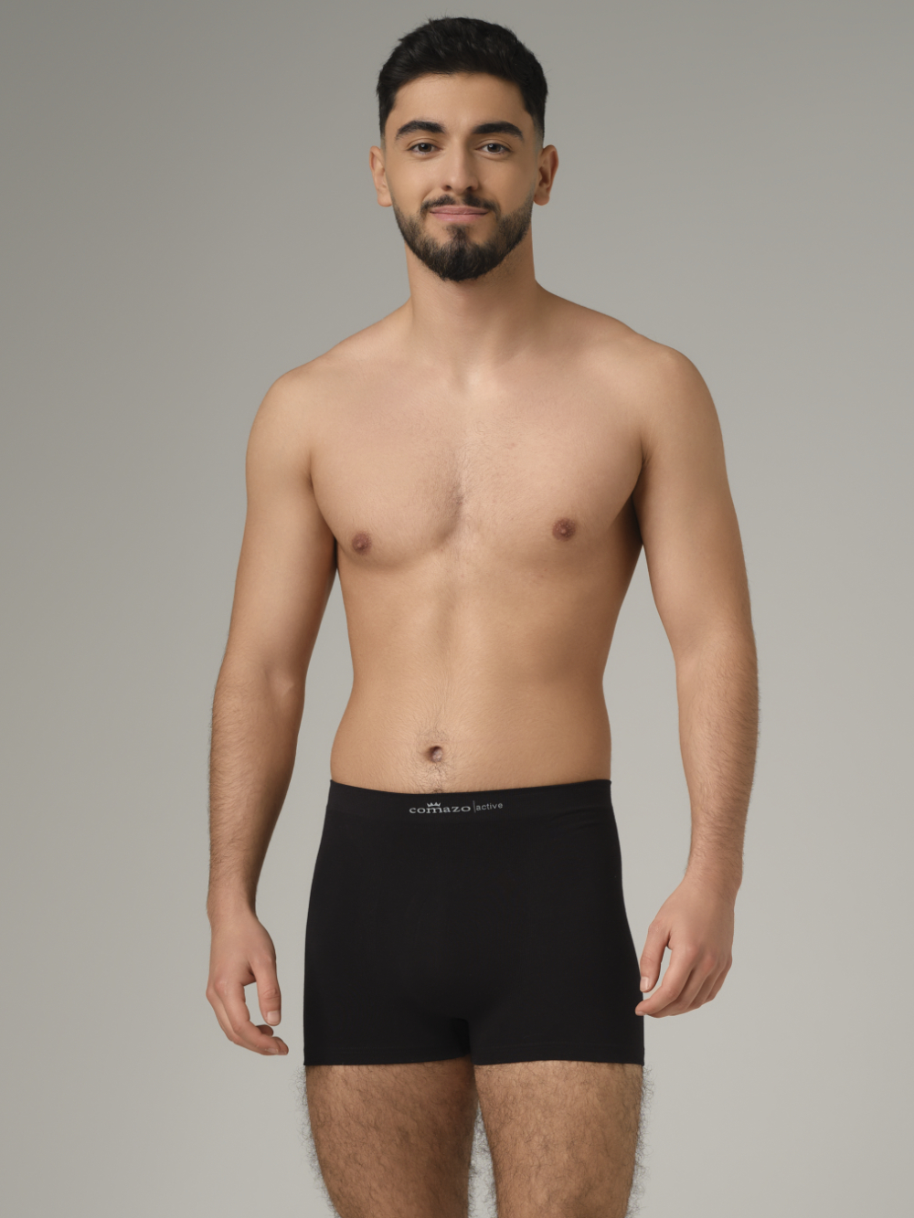 Comazo men's seamless trunk in black color. Front view: man wearing seamless trunks by Comazo in the color black.
