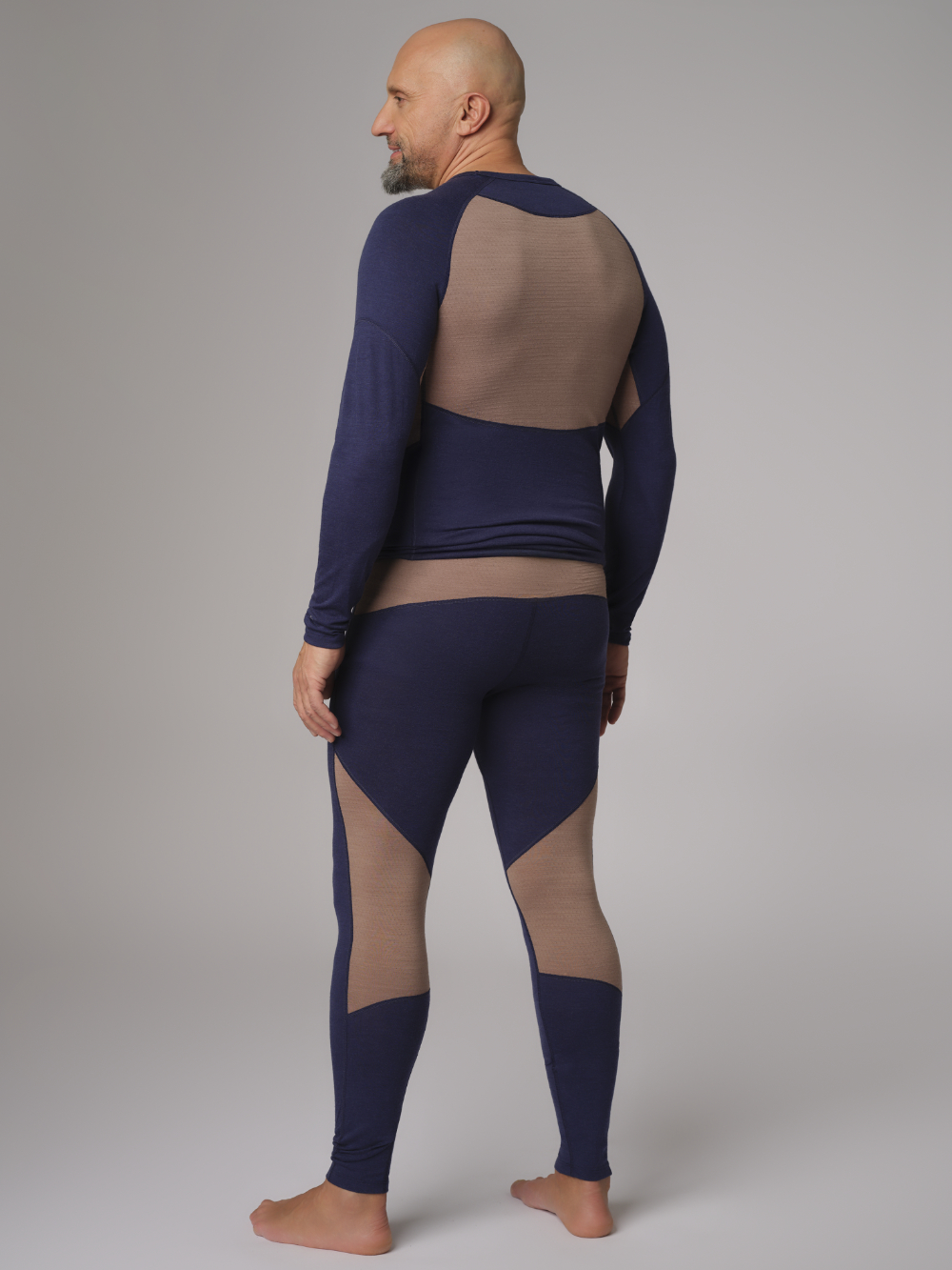 Comazo men's long underpants made of merino wool, color dark blue/coffee. Back view: Man wearing Comazo men's long underpants made of merino wool, color dark blue/coffee.