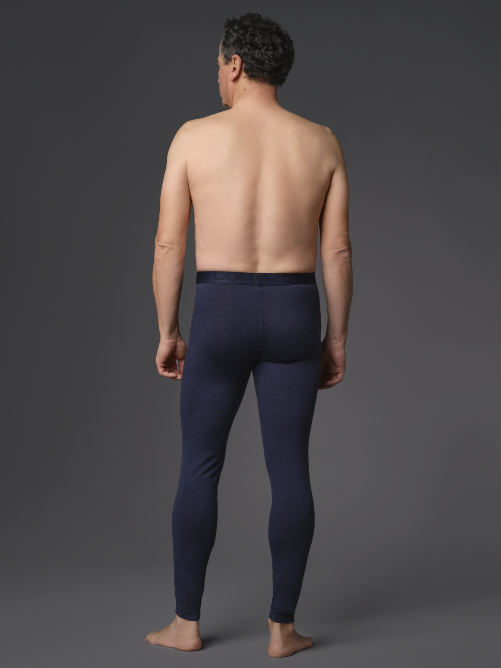 Functional pants made of 100% merino wool for men by Comazo Protect, color navy. Back view: Man wearing functional pants made of 100% merino wool for men by Comazo Protect, color navy.