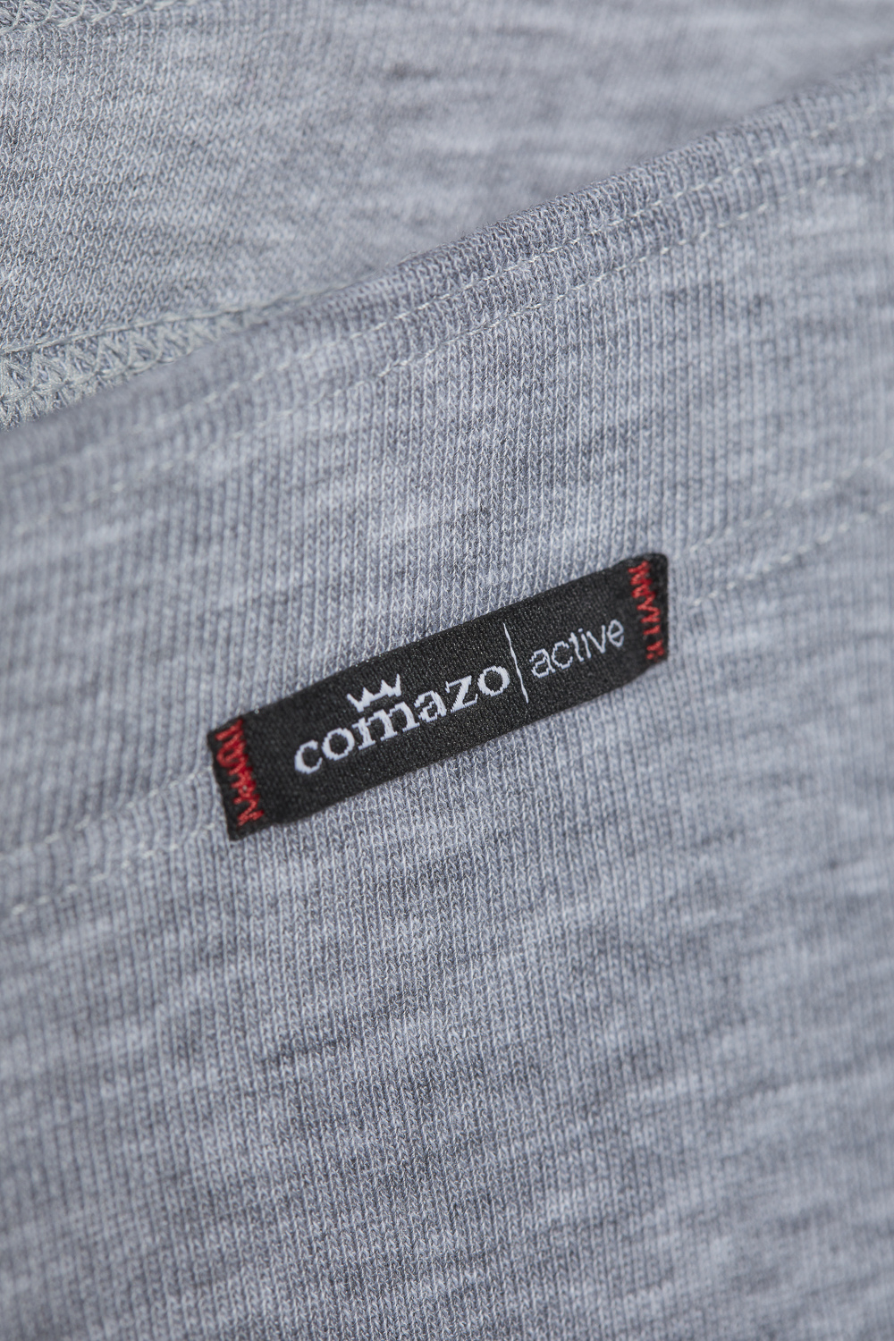 Comazo unisex 3/4 functional pants "warm extra", color gray melange. Detail image Unisex 3/4 functional pants "warm extra" by Comazo in gray melange, with a brushed inner lining for optimal heat retention and quick-drying functional fabric thanks to excellent moisture management.